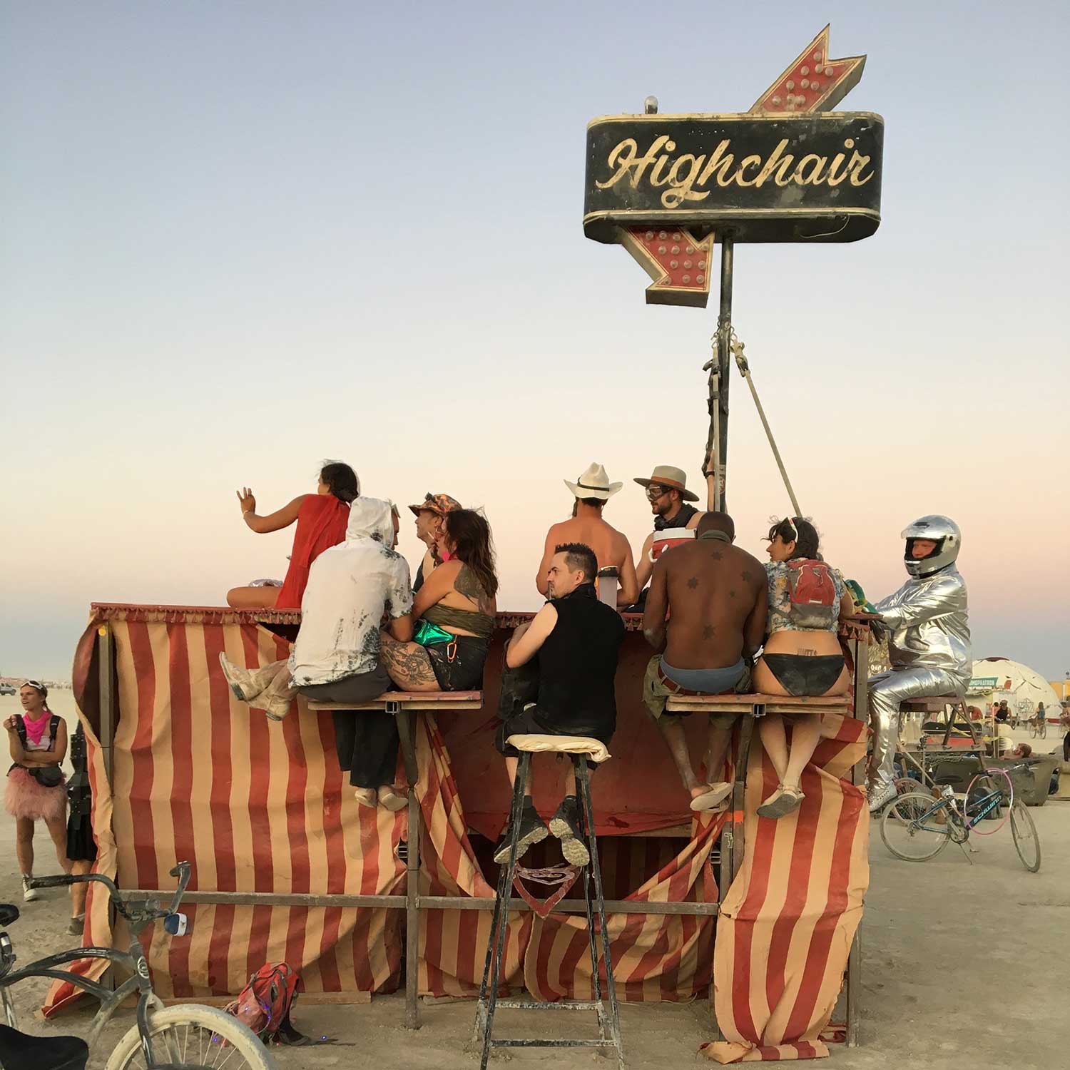 Festival participants perched atop the Highchair art installation