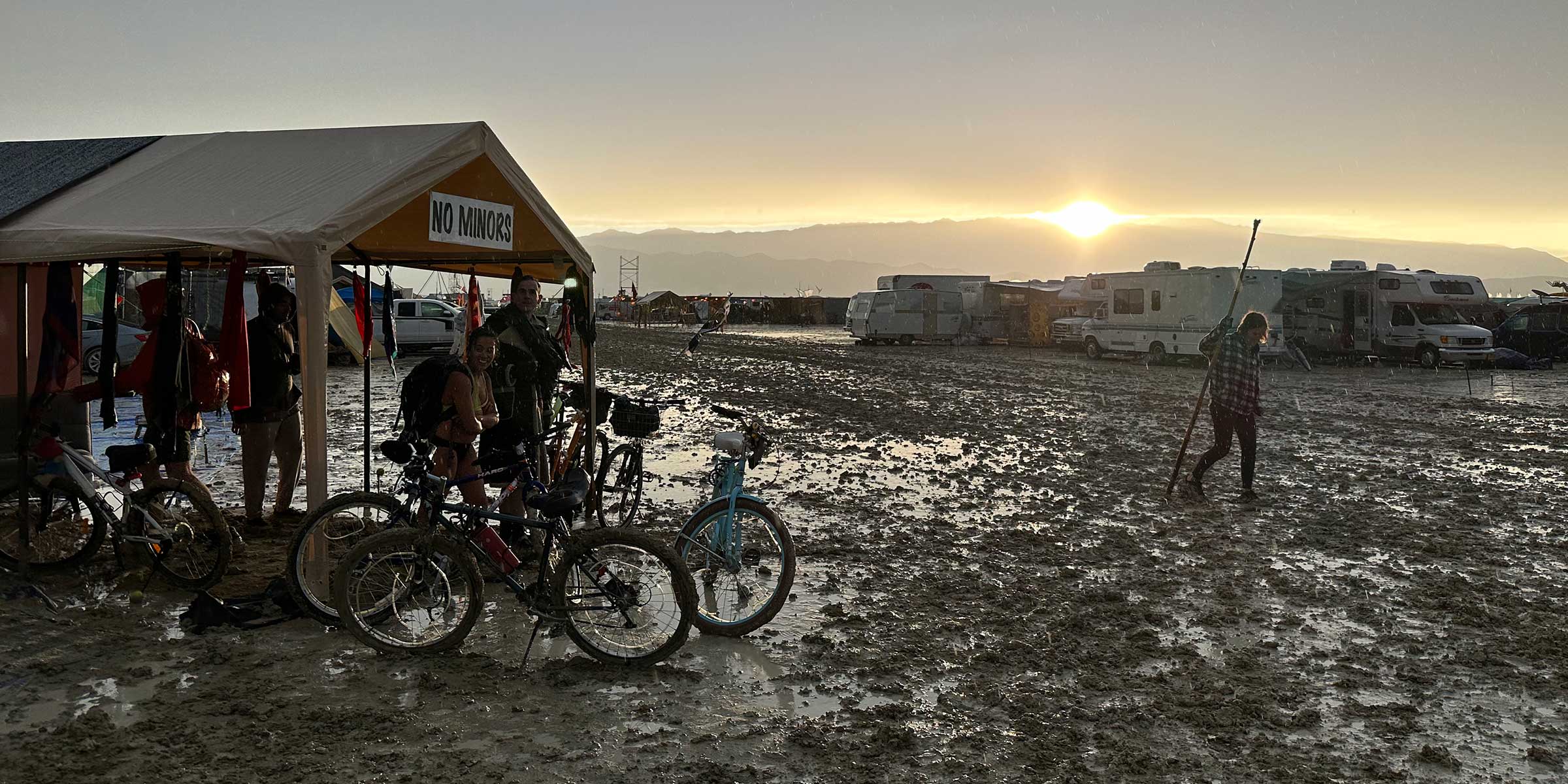 Festival camp flooded with mud after rain at sunrise