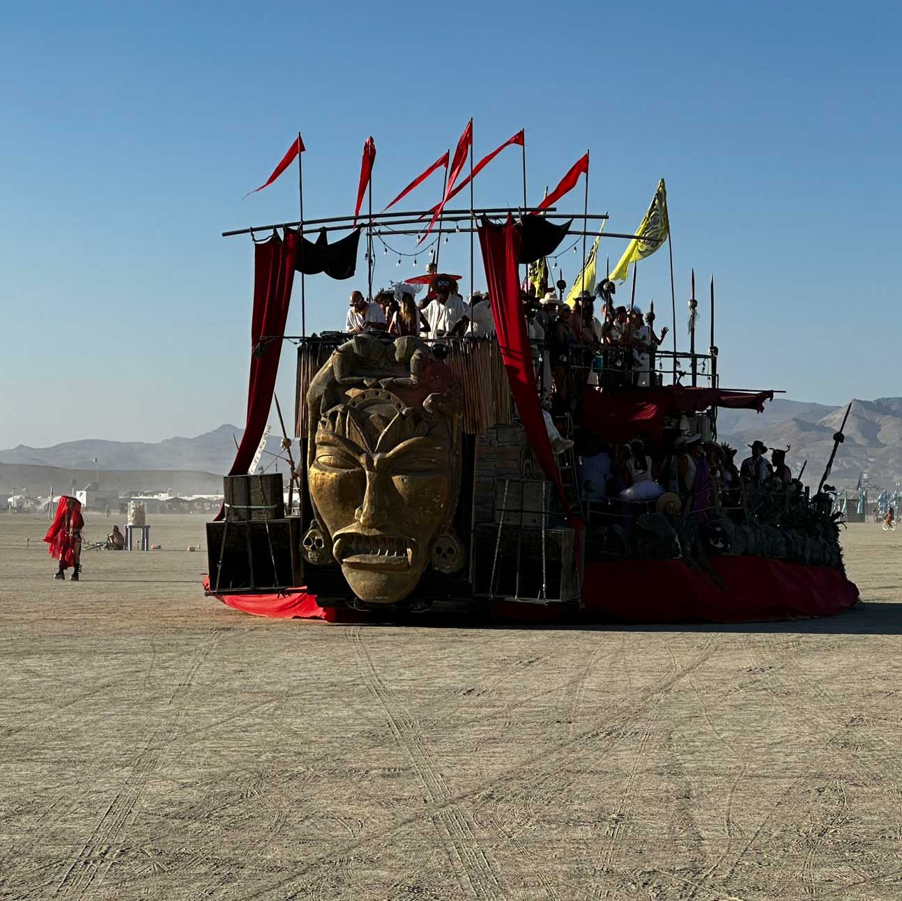 Warrior tribal art car with giant face and red banners