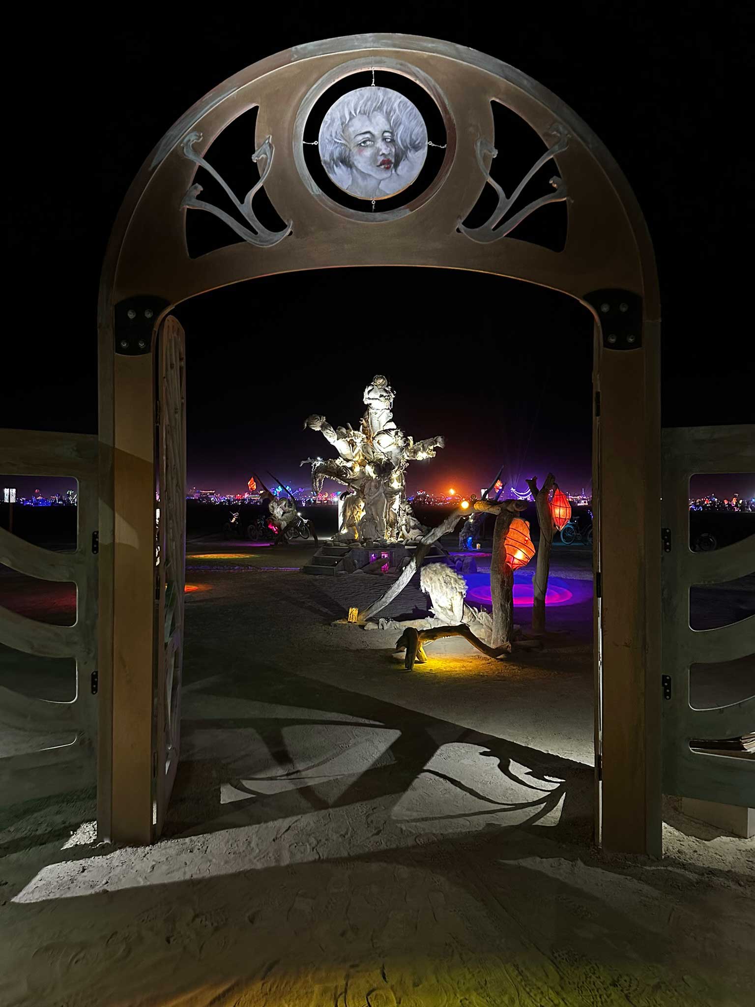 Burning Man art installation viewed through ornate arch doorway